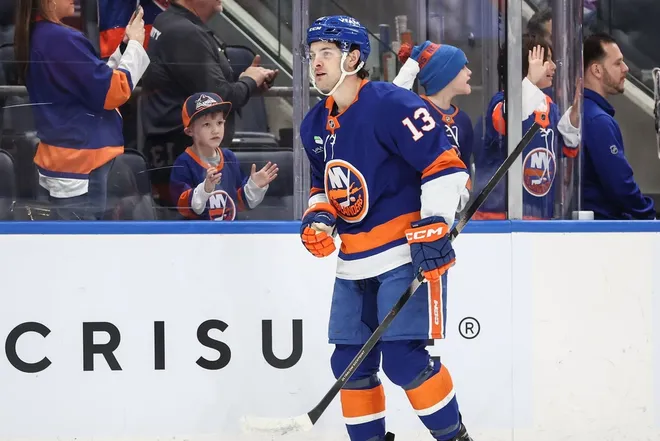 Jan 31, 2026; Elmont, New York, USA; New York Islanders center Mathew Barzal (13) celebrates with after scoring a goal in the first period against the Nashville Predators at UBS Arena.