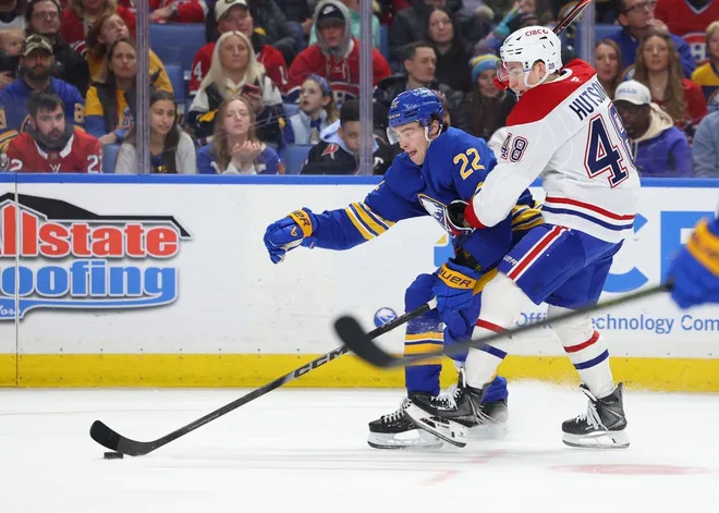 Jan 31, 2026; Buffalo, New York, USA; Buffalo Sabres right wing Jack Quinn (22) tries to control the puck as Montréal Canadiens defenseman Lane Hutson (48) defends during the third period at KeyBank Center.