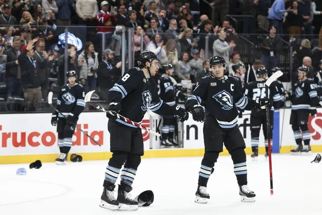 Feb 2, 2026; Salt Lake City, Utah, USA; Utah Mammoth center Nick Schmaltz (8) celebrates after scoring a third goal for a hat trick with right wing Clayton Keller (9) during the third period of the game against the Vancouver Canucks at Delta Center.