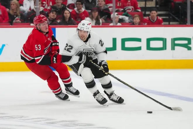 Feb 1, 2026; Raleigh, North Carolina, USA; aLos Angeles Kings left wing Kevin Fiala (22) skates with the puck past Carolina Hurricanes right wing Jackson Blake (53) during the first period t Lenovo Center.