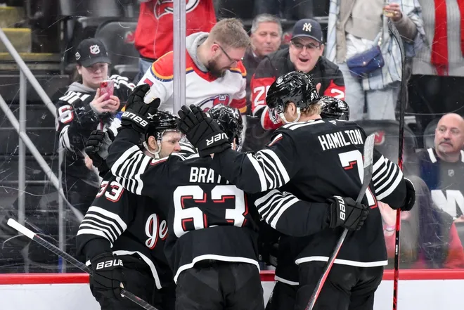 Feb 5, 2026; Newark, New Jersey, USA; New Jersey Devils center Nico Hischier (13) celebrates with teammates after scoring a goal against the New York Islanders during the second period at Prudential Center.