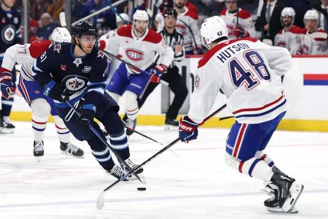 Feb 4, 2026; Winnipeg, Manitoba, CAN; Winnipeg Jets left wing Kyle Connor (81) skates up the ice to Montreal Canadiens defenseman Lane Hutson (48) in the second period at Canada Life Centre.