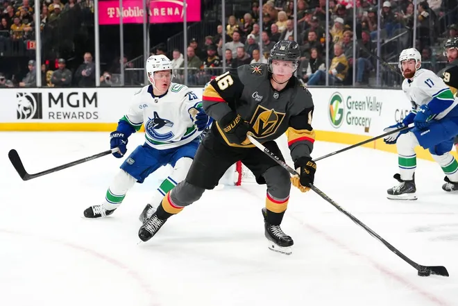 Feb 4, 2026; Las Vegas, Nevada, USA; Vegas Golden Knights right wing Pavel Dorofeyev (16) controls the puck ahead of Vancouver Canucks defenseman Elias Pettersson (25) during the second period at T-Mobile Arena.