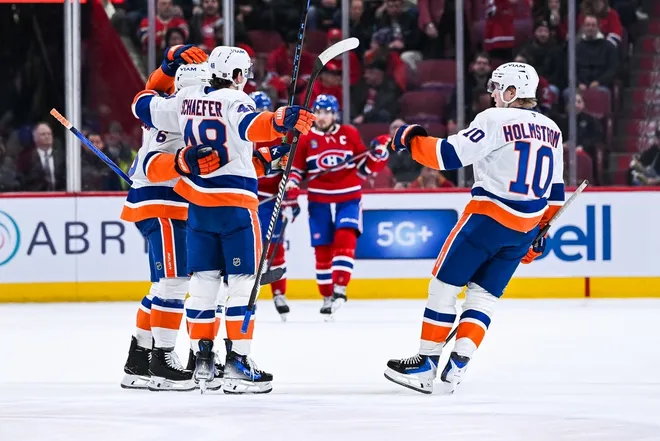 Feb 26, 2026; Montreal, Quebec, CAN; New York Islanders defenseman Matthew Schaefer (48) celebrates with right wing Simon Holmstrom (10) his second goal of the game against the Montreal Canadiens during the second period at Bell Centre.