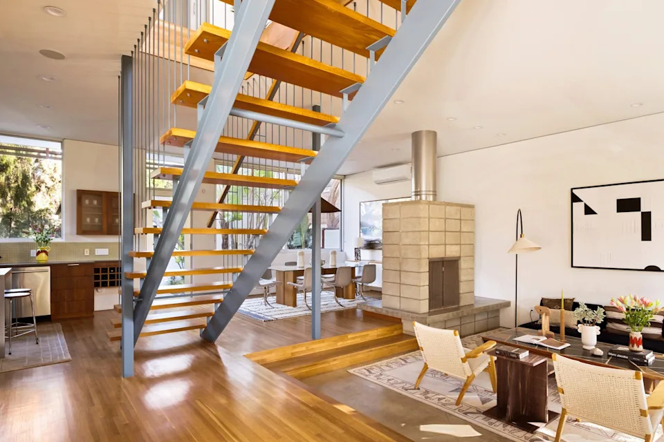 The sunken living room shares a dual fireplace with the dining area. <span class="image-credit">(Engles Studios)</span>