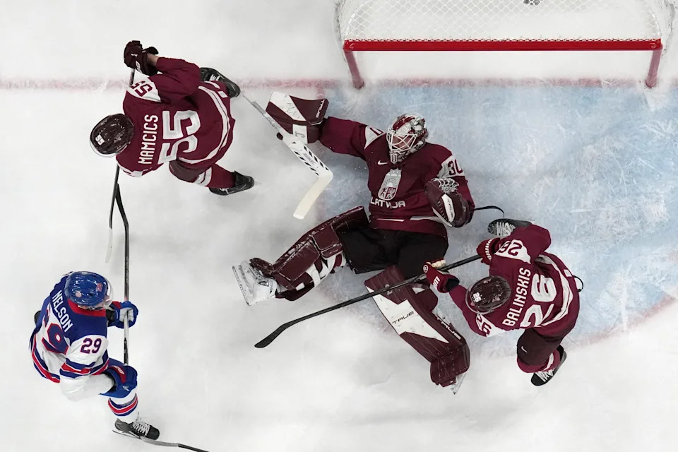 [US, Mexico & Canada customers only] Feb 12, 2026; Milan, Italy; Roberts Mamcics of Latvia, Uvis Janis Balinskis of Latvia, and Elvis Merzlikins of Latvia in action with Brock Nelson of United States in men's ice hockey group C play during the Milano Cortina 2026 Olympic Winter Games at Milano Santagiulia Ice Hockey Arena. Mandatory Credit: Mike Segar/Reuters via Imagn Images