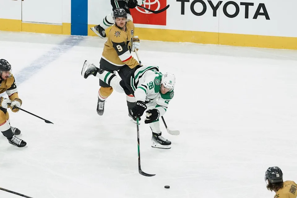 Dallas Stars right wing Mikko Rantanen (96) reaches for the puck while  Golden Knights center Jack Eichel (9) skates behind him during first period of NHL game against Vegas Golden Knights on Thursday Jan. 29, 2026 at T-Mobile Arena in Las Vegas.