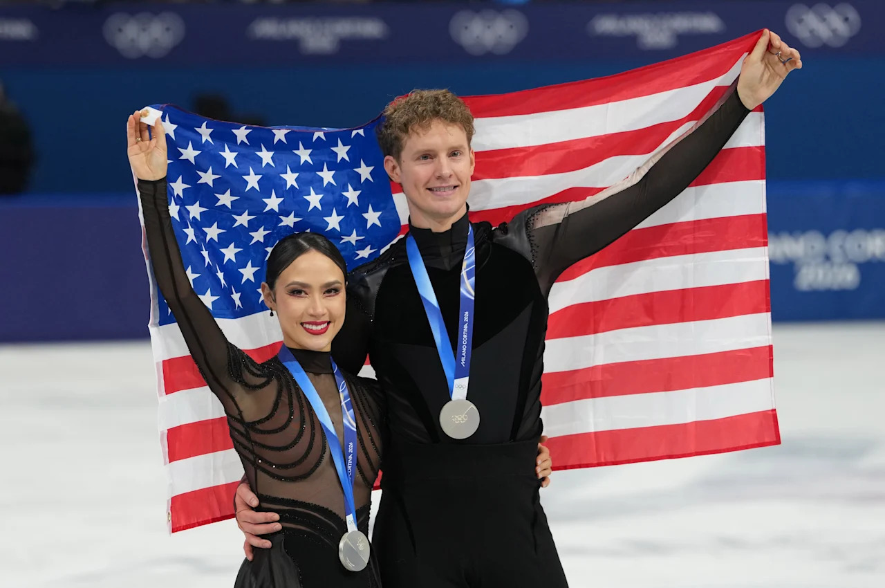 iFeb 11, 2026; Milan, Italy; Madison Chock and Evan Bates of the United States skate after receiving silver medals during the Milano Cortina 2026 Olympic Winter Games at Milano Ice Skating Arena. Mandatory Credit: James Lang-Imagn Images
