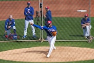 Texas Rangers pitcher Kumar Rocker throws live batting practice during a spring training...