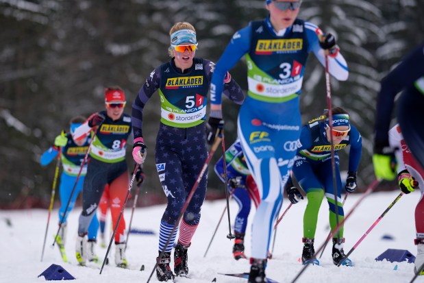 Hailey Swirbul, of the United States, center, competes in the Women's Cross Country 4 X 5 KM Relay Classic event at the Nordic World Championships in Planica, Slovenia, Thursday, March 2, 2023. (AP Photo/Matthias Schrader)