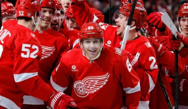 Detroit Red Wings right wing Patrick Kane (88) is surrounded by teammates after recording his 1,375th point to pass Mike Modano and break the NHL record for points by a player born in the United States, during the second period of an NHL hockey game Thursday, Jan. 29, 2026, in Detroit. (AP Photo/Duane Burleson)