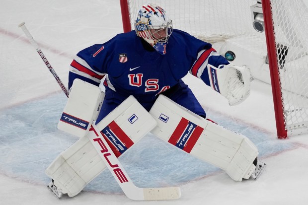 United States' goalkeeper Jeremy Swayman makes a save during a preliminary round match of men's ice hockey between United States and Denmark at the 2026 Winter Olympics, in Milan, Italy, Saturday, Feb. 14, 2026. (AP Photo/Petr David Josek)