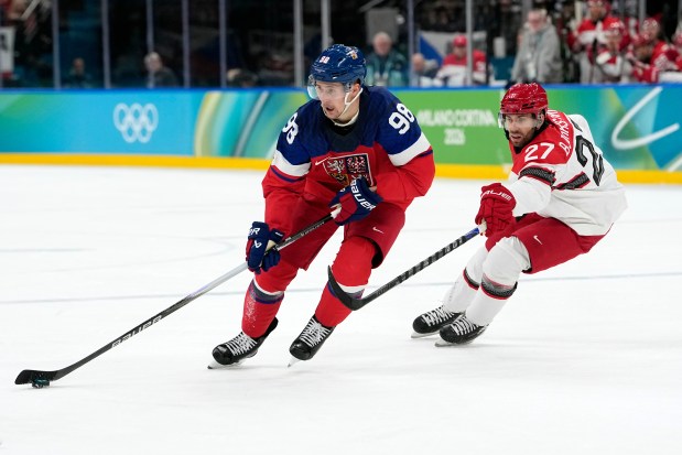 Czechia's Martin Necas (98) skates ahead of Denmark's Oliver Bjorkstrand (27) during the second period of a men's ice hockey qualification playoff game at the 2026 Winter Olympics, in Milan, Italy, on Tuesday, Feb. 17, 2026. (AP Photo/Hassan Ammar)