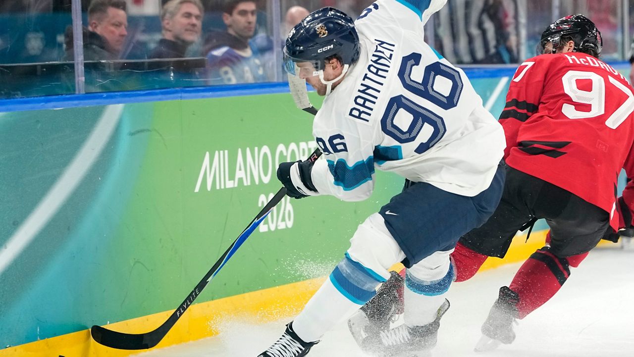 Finland's Mikko Rantanen (96) challenges with Canada's Connor McDavid (97) during a men's ice hockey semifinal game between Canada and Finland at the 2026 Winter Olympics, in Milan, Italy, Friday, Feb. 20, 2026. (AP Photo/Hassan Ammar)