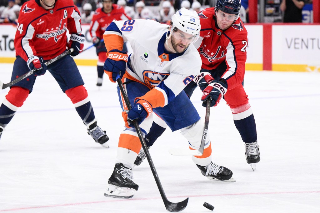 Islanders left wing Jonathan Drouin skates with the puck in front of Capitals center Aliaksei Protas during the second period on Monday, Feb. 2, 2026, in Washington. 