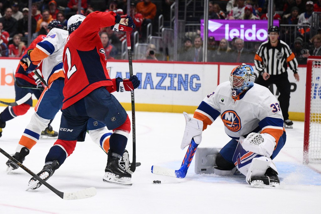 Islanders goaltender David Rittich clears the puck against Capitals left wing Anthony Beauvillier (left) during the second period on Monday, Feb. 2, 2026, in Washington. 