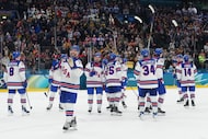United States players applaud fans at the end of a preliminary round game of men's ice...