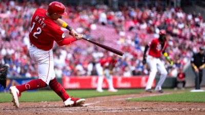 Cincinnati Reds left fielder Austin Hays (12) hits an RBI base hit in the sixth inning between Cincinnati Reds and New York Mets at Great American Ball Park in Cincinnati on Sept. 7, 2025.