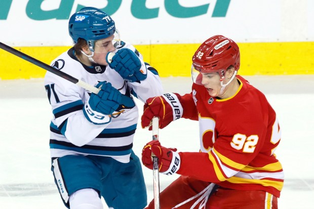 San Jose Sharks' Macklin Celebrini (71) collides with Calgary Flames' Matvei Gridin during the first period of an NHL hockey games in Calgary, Saturday, Jan. 31, 2026. (Larry MacDougal/The Canadian Press via AP)