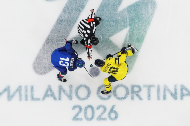 MILAN, ITALY - FEBRUARY 11: (EDITOR'S NOTE: Image was captured using a remote camera positioned above the field of play.) Matt Bradley #13 of Team Italy and Alexander Wennberg #10 of Team Sweden face off in the first period during the Men's Preliminary Group B match between Sweden and Italy on day five of the Milano Cortina 2026 Winter Olympic games at Milano Santagiulia Ice Hockey Arena on February 11, 2026 in Milan, Italy. (Photo by Bruce Bennett/Getty Images)