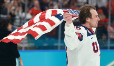 Charlie McAvoy (Bruins) skates with a USA flag after beating Canada 2-1 in the gold medal game