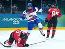 Abbey Murphy (37) of Team United States celebrates after a goal by Hannah Bilka (23) as Team Canada players look on during second-period Olympic hockey action at the 2026 Milan Cortina Winter Olympics in Milan, Italy on Tuesday, Feb. 10, 2026. 
