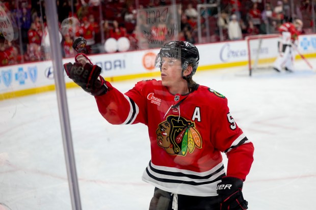 Blackhawks defenseman Connor Murphy tosses a puck into the stands before a game against the Sharks on Feb. 2, 2026, at the United Center. (Armando L. Sanchez/Chicago Tribune)