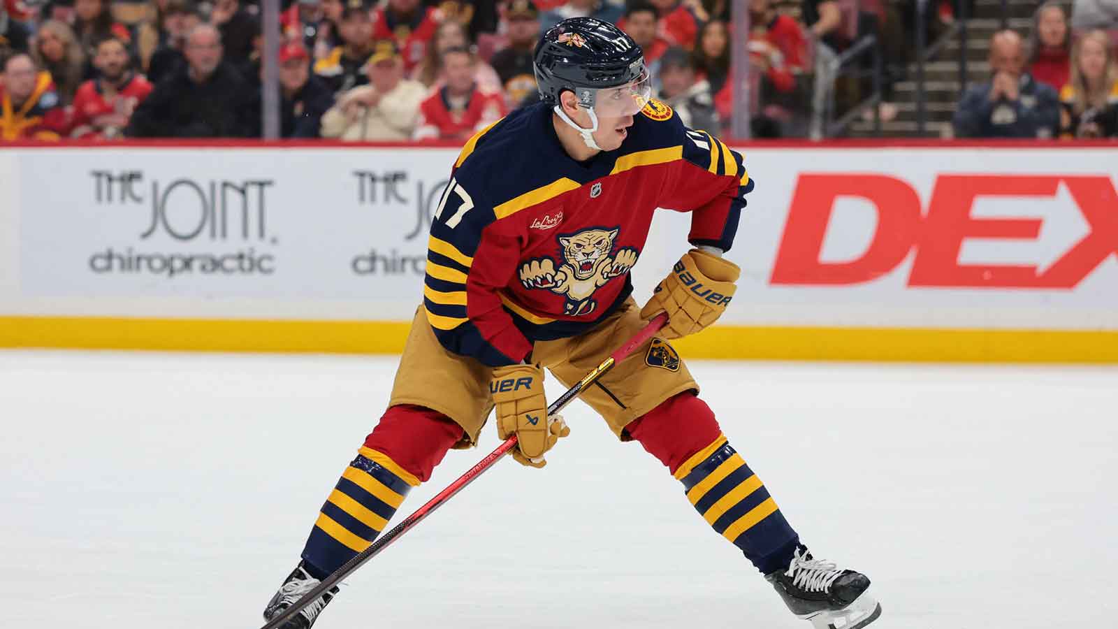 Florida Panthers center Evan Rodrigues (17) moves the puck against the Boston Bruins during the first period at Amerant Bank Arena. 