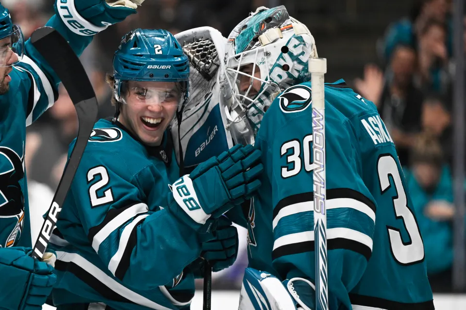 Goaltender Yaroslav Askarov of the San Jose Sharks celebrates with teammate Will Smith on the ice