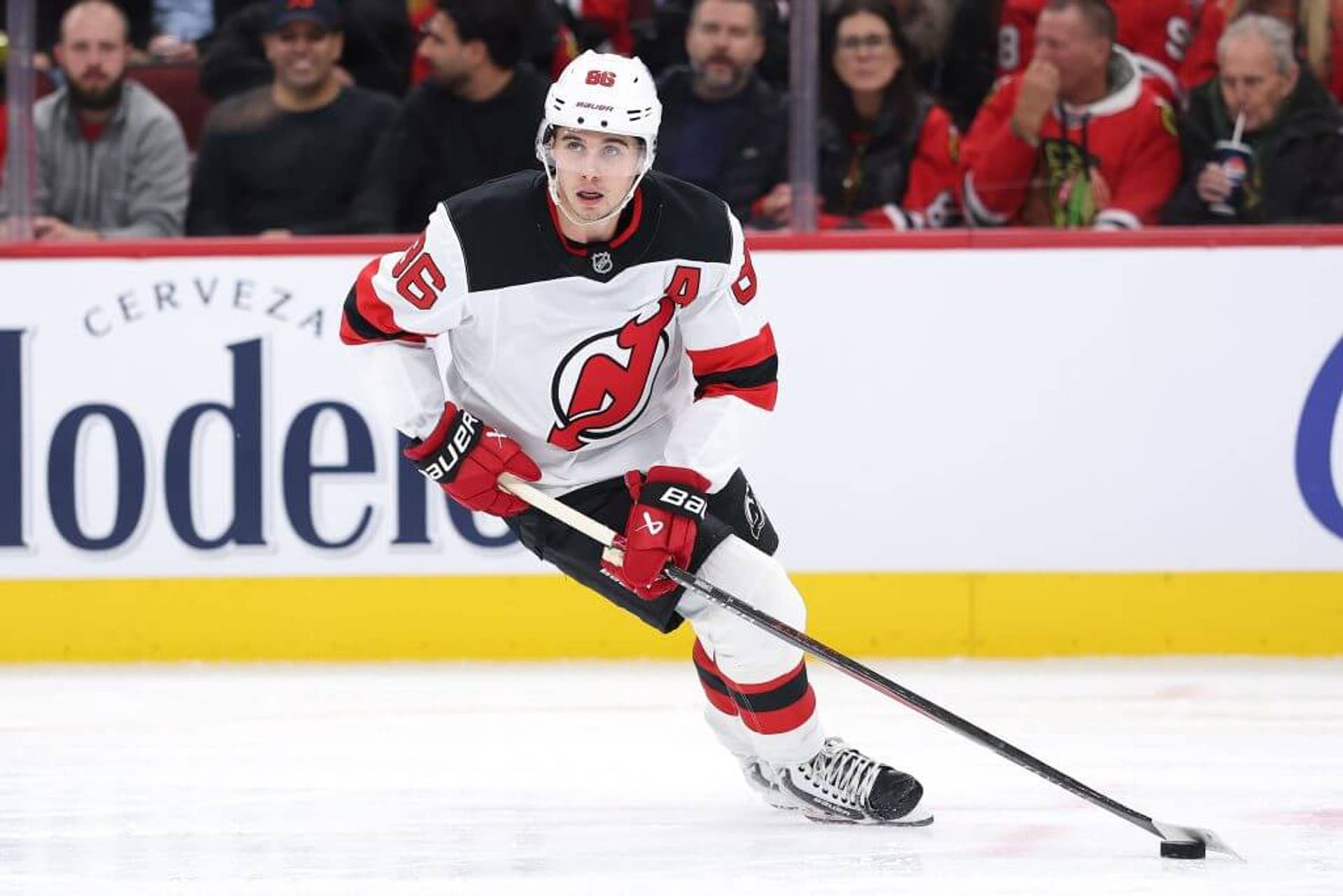 Jack hughes of New Jersey Devils skates with the puck