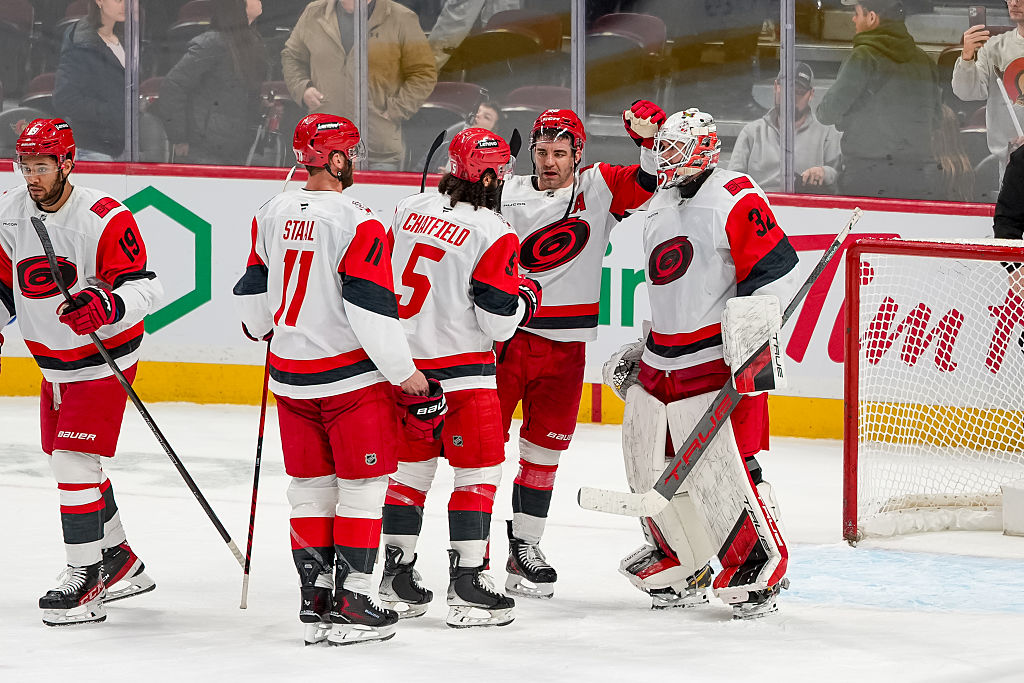 OTTAWA, ONTARIO - JANUARY 24: Brandon Bussi #32 of the Carolina Hurricanes celebrates a win with teammates Jordan Staal #11, Jalen Chatfield #5 and Jordan Martinook #48 after the game against the Ottawa Senators at Canadian Tire Centre on January 24, 2026 in Ottawa, Ontario. (Photo by Reuben Polansky-Shapiro/NHLI via Getty Images)