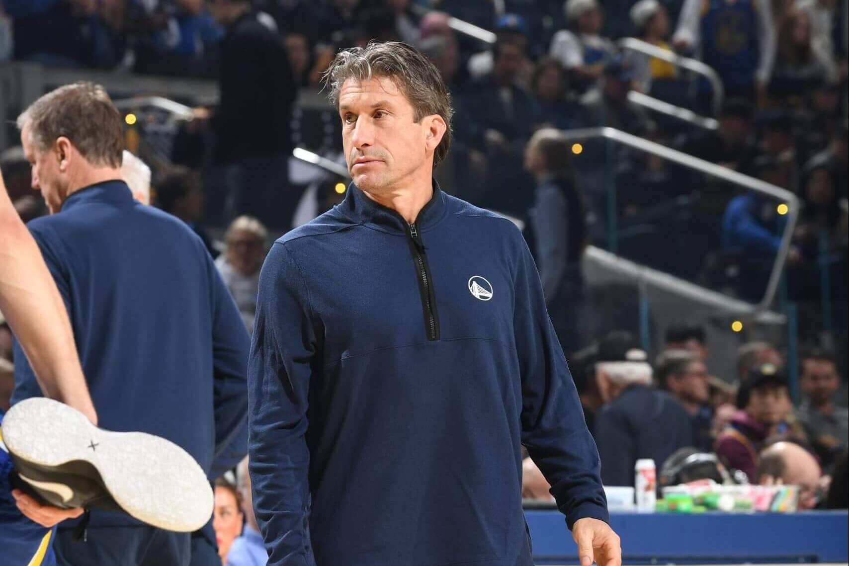 Rick Celebrini stands courtside during a Golden State Warriors game.