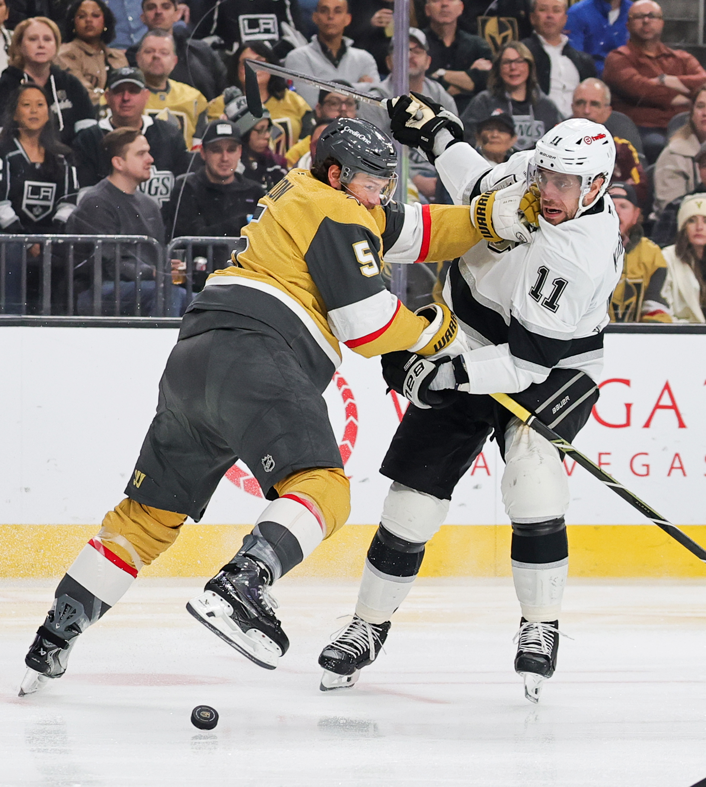 The Vegas Golden Knights’ Jeremy Lauzon, left, knocks Kings captain...