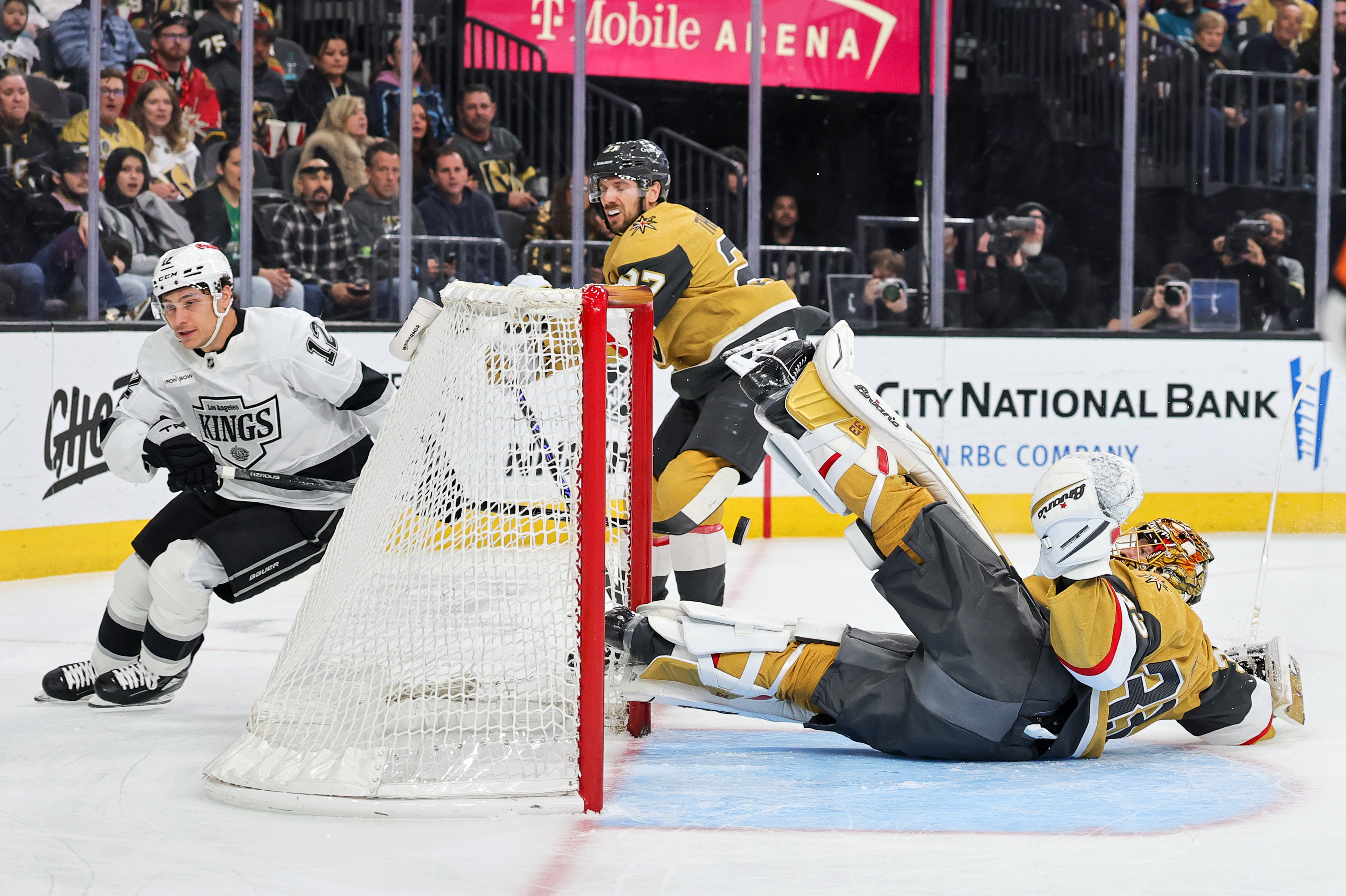 The Kings’ Trevor Moore, left, scores a first-period goal past...