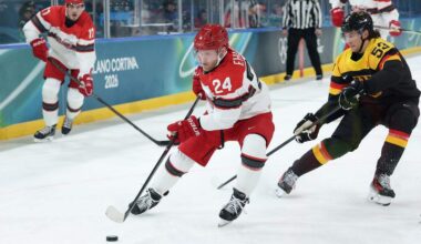 Nikolaj Ehlers (24) of Team Denmark skates with the puck against Moritz Seider of Team Germany in the first period during the Men's Preliminary Group C match between Germany and Denmark on day six of the Milano Cortina 2026 Winter Olympic games at Milano Rho Ice Hockey Arena on February 12, 2026 in Milan, Italy.
