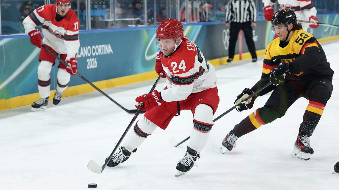 Nikolaj Ehlers (24) of Team Denmark skates with the puck against Moritz Seider of Team Germany in the first period during the Men's Preliminary Group C match between Germany and Denmark on day six of the Milano Cortina 2026 Winter Olympic games at Milano Rho Ice Hockey Arena on February 12, 2026 in Milan, Italy.