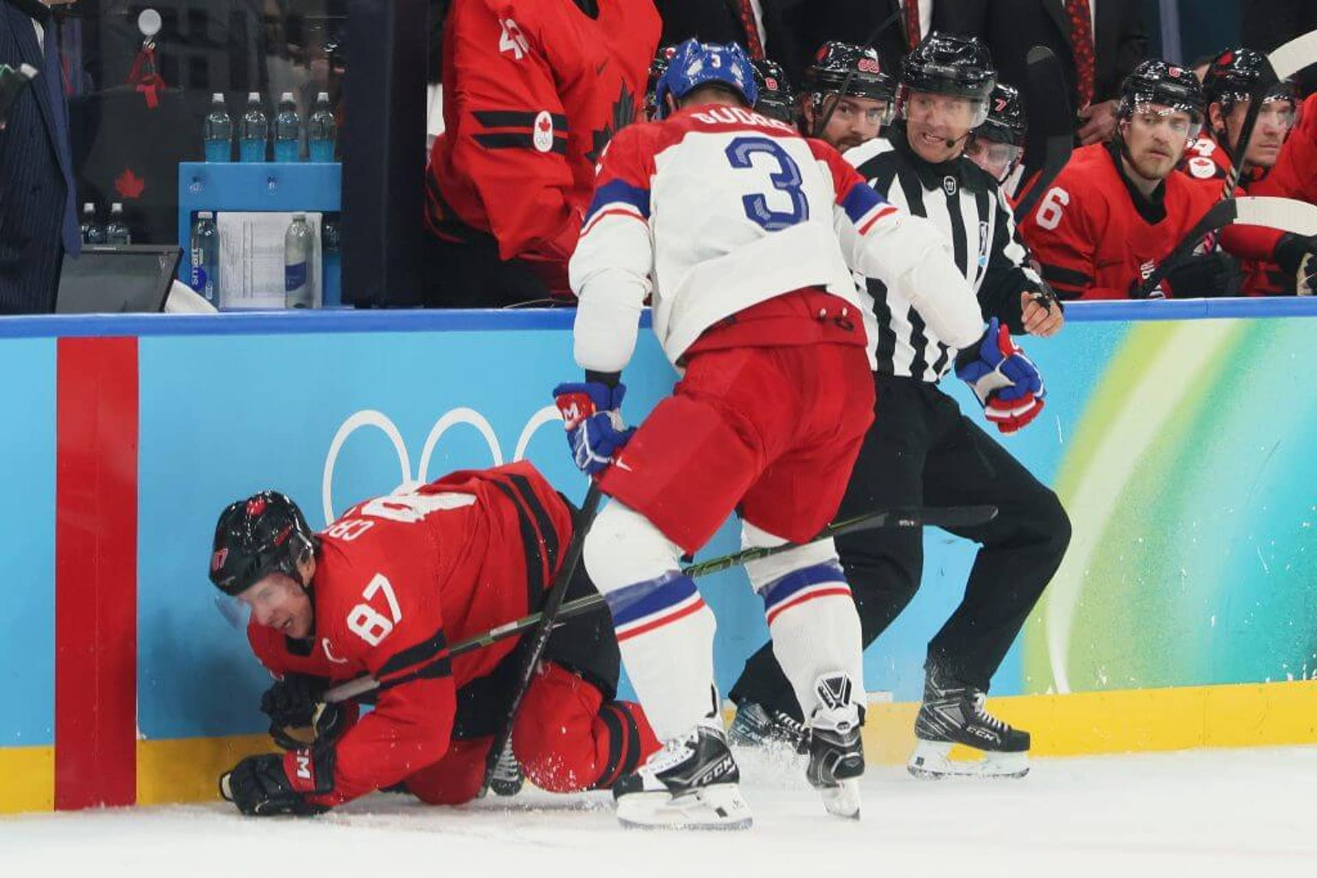 Sidney Crosby is challenged by Radko Gudas during Canada's Olympic men's hockey qualifying game