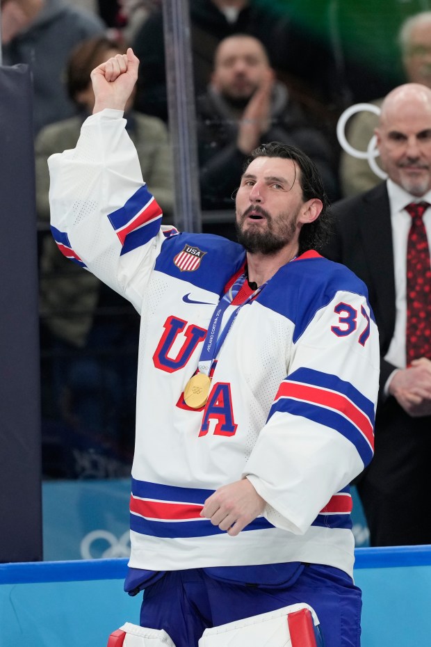 United States goaltender Connor Hellebuyck celebrates after the men's ice hockey gold medal game between Canada and the United States at the 2026 Winter Olympics, in Milan, Italy, Sunday, Feb. 22, 2026. (AP Photo/Hassan Ammar)