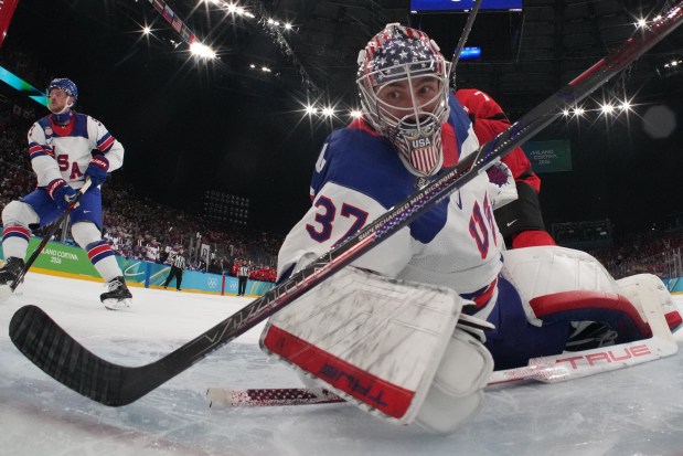 United States goaltender Connor Hellebuyck reacts during a men's ice hockey gold medal game between Canada and the United States at the 2026 Winter Olympics, in Milan, Italy, Sunday, Feb. 22, 2026. Behind him is Jack Eichel, a North Chelmsford native. (Mike Segar/Pool Photo via AP)