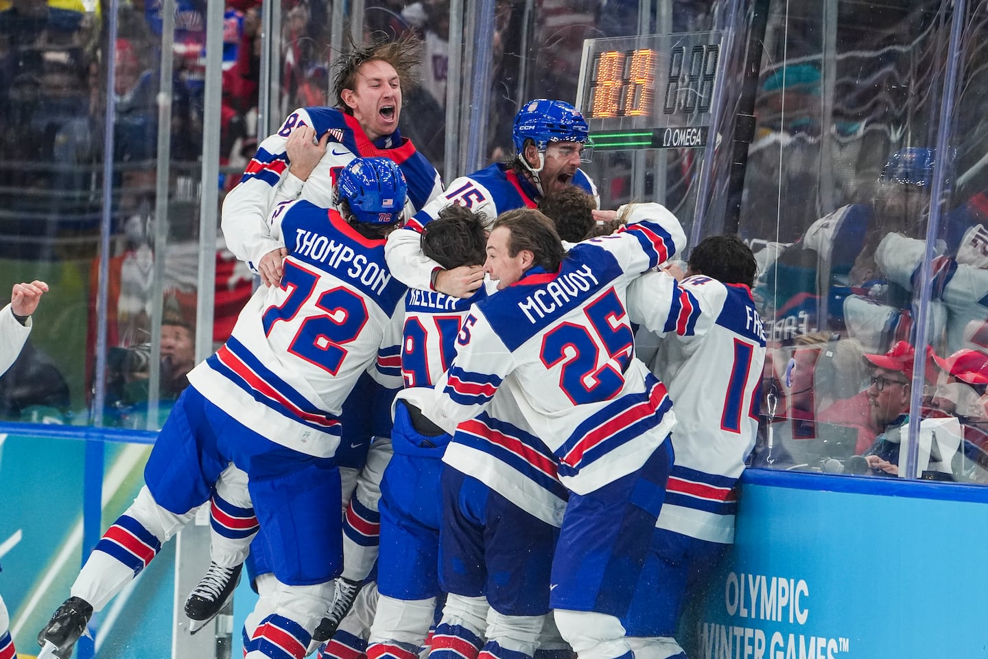 Defenseman Charlie McAvoy (25) and the rest of the United States men's hockey team go crazy after beating Canada in overtime to win the gold medal at the Milan Cortina Olympic Games on Sunday.