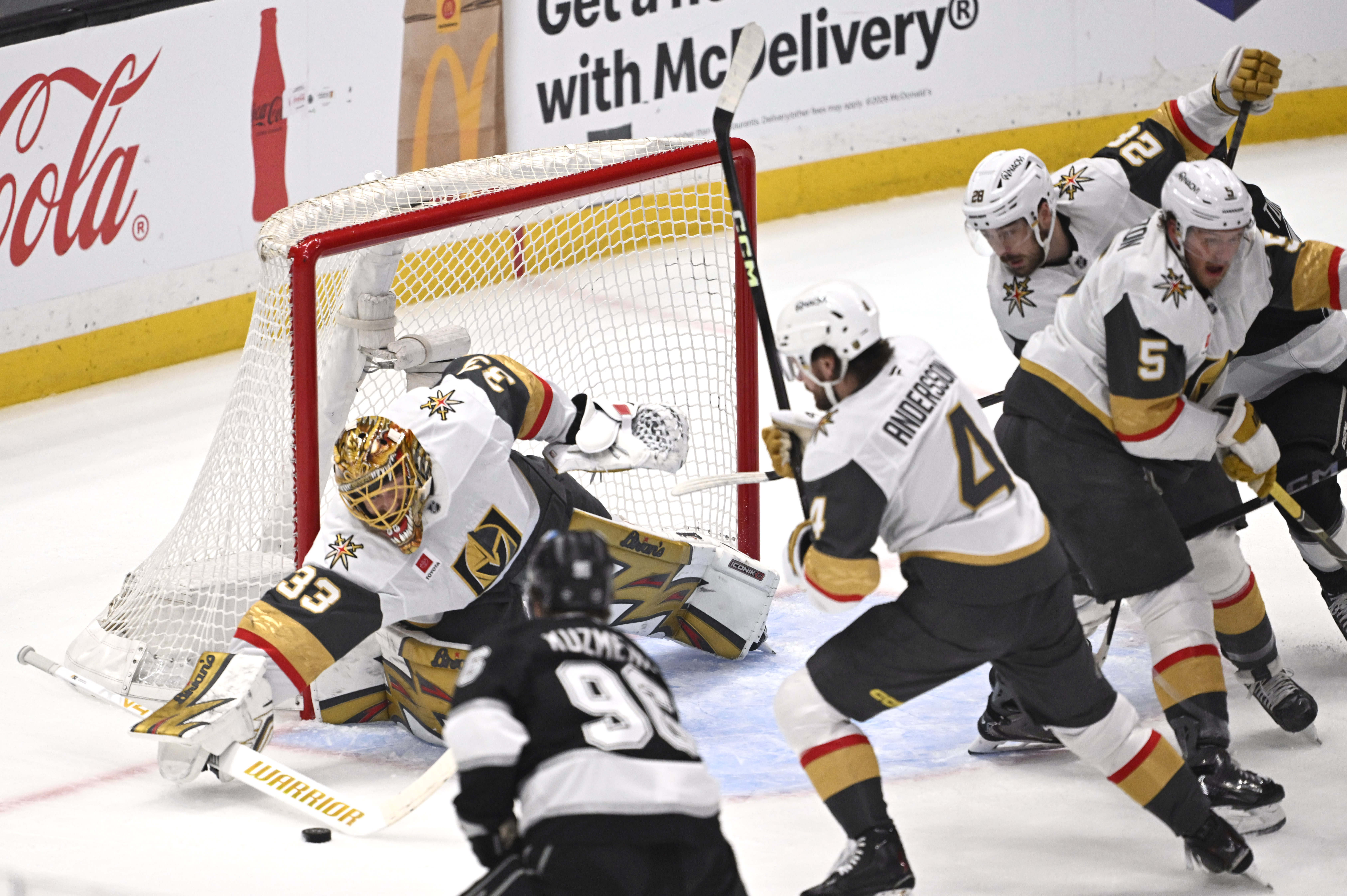 Vegas Golden Knights goaltender Adin Hill, left, blocks a shot...