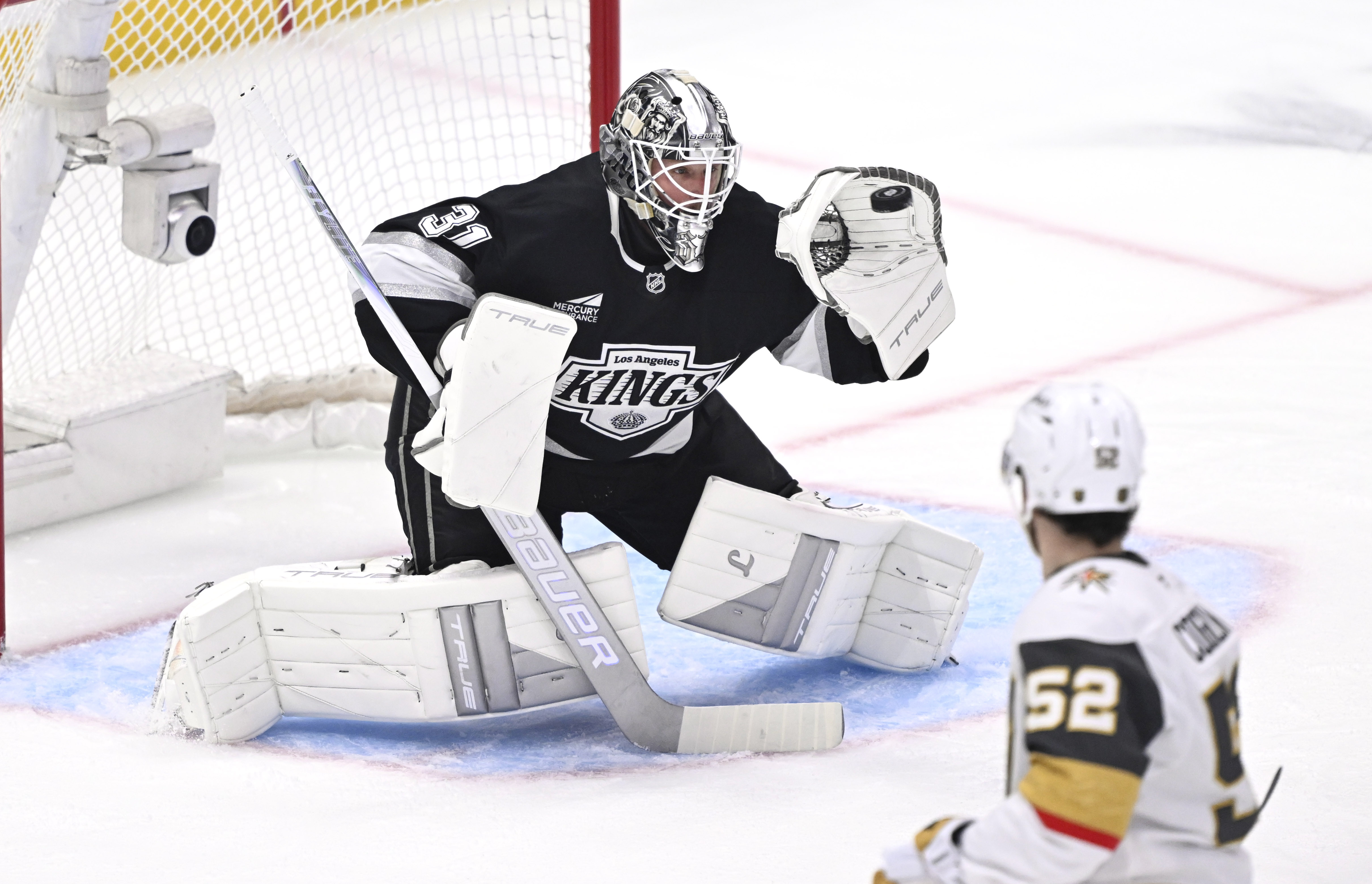 Kings goaltender Anton Forsberg gloves a shot as Vegas Golden...