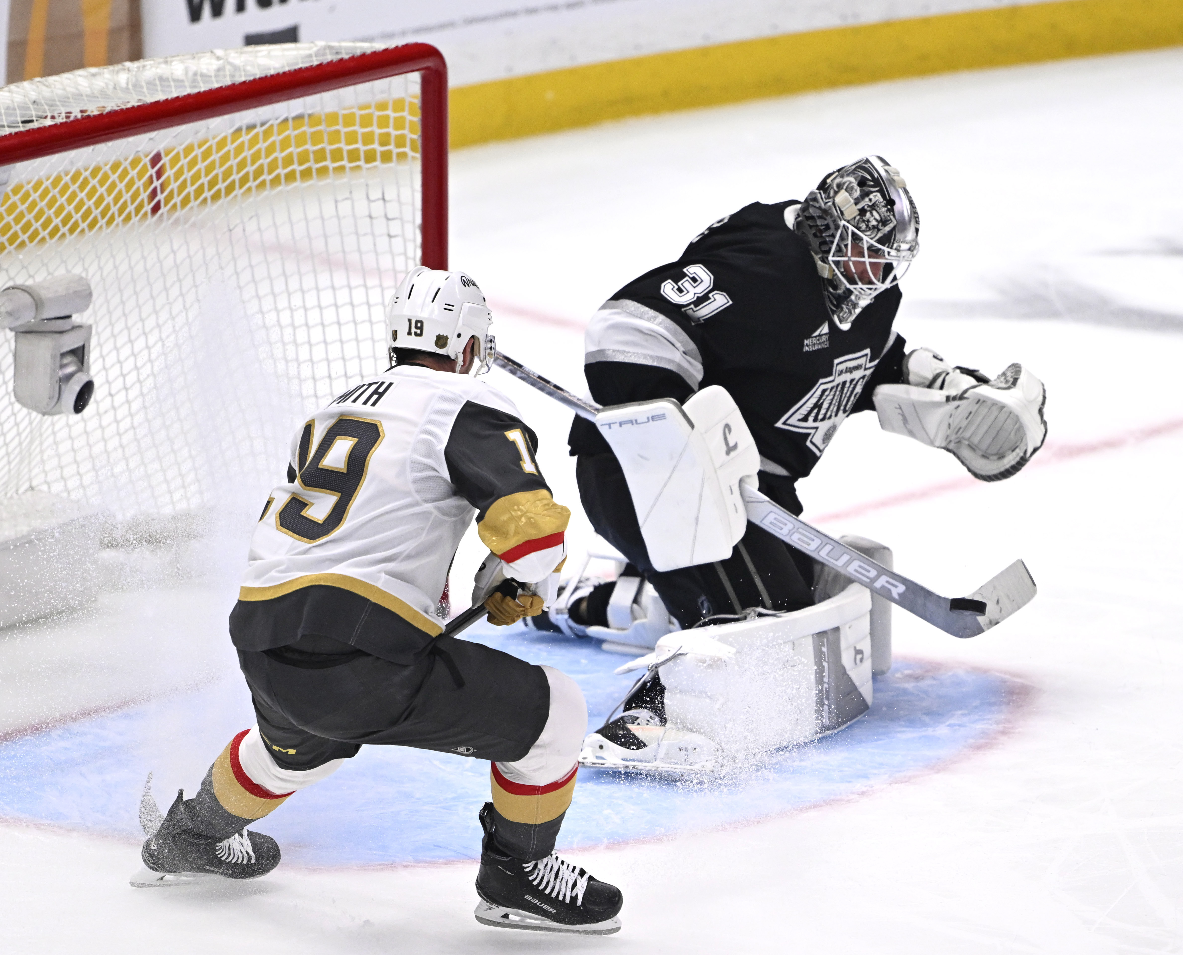 Kings goaltender Anton Forsberg, right, blocks a shot as Vegas...