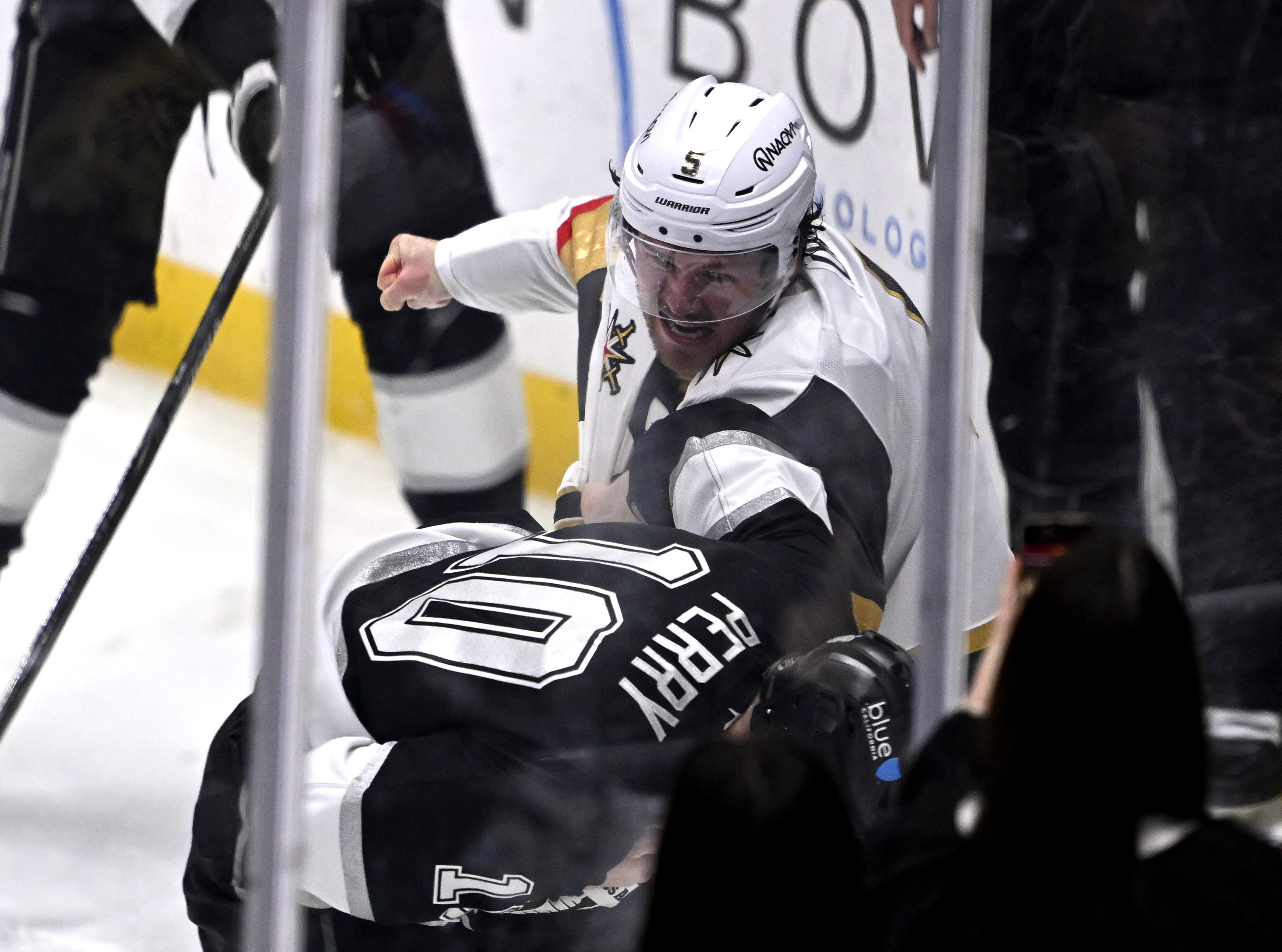 Vegas Golden Knights defenseman Jeremy Lauzon, top, punches Kings right...