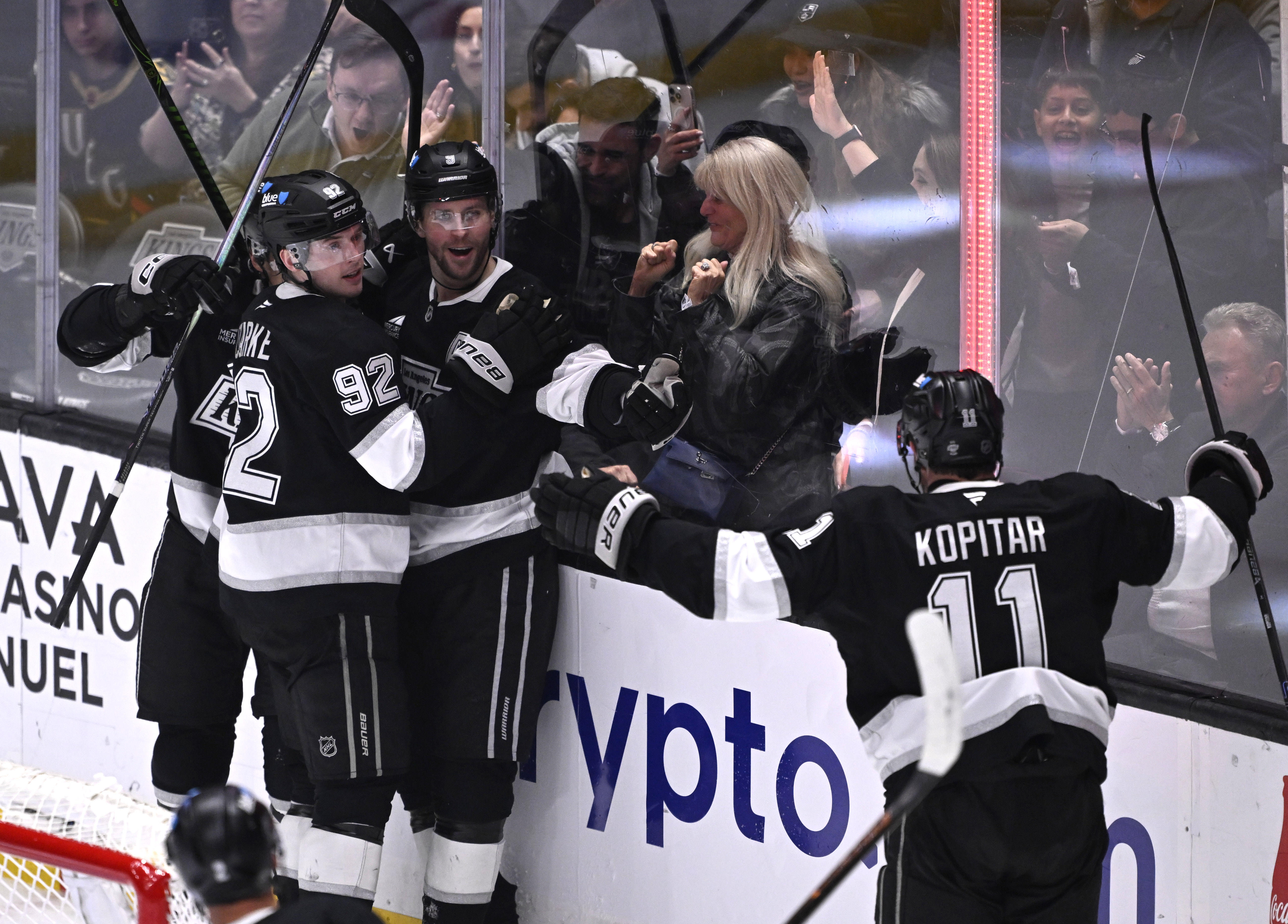 Kings right wing Adrian Kempe (9) celebrates with teammates, including...