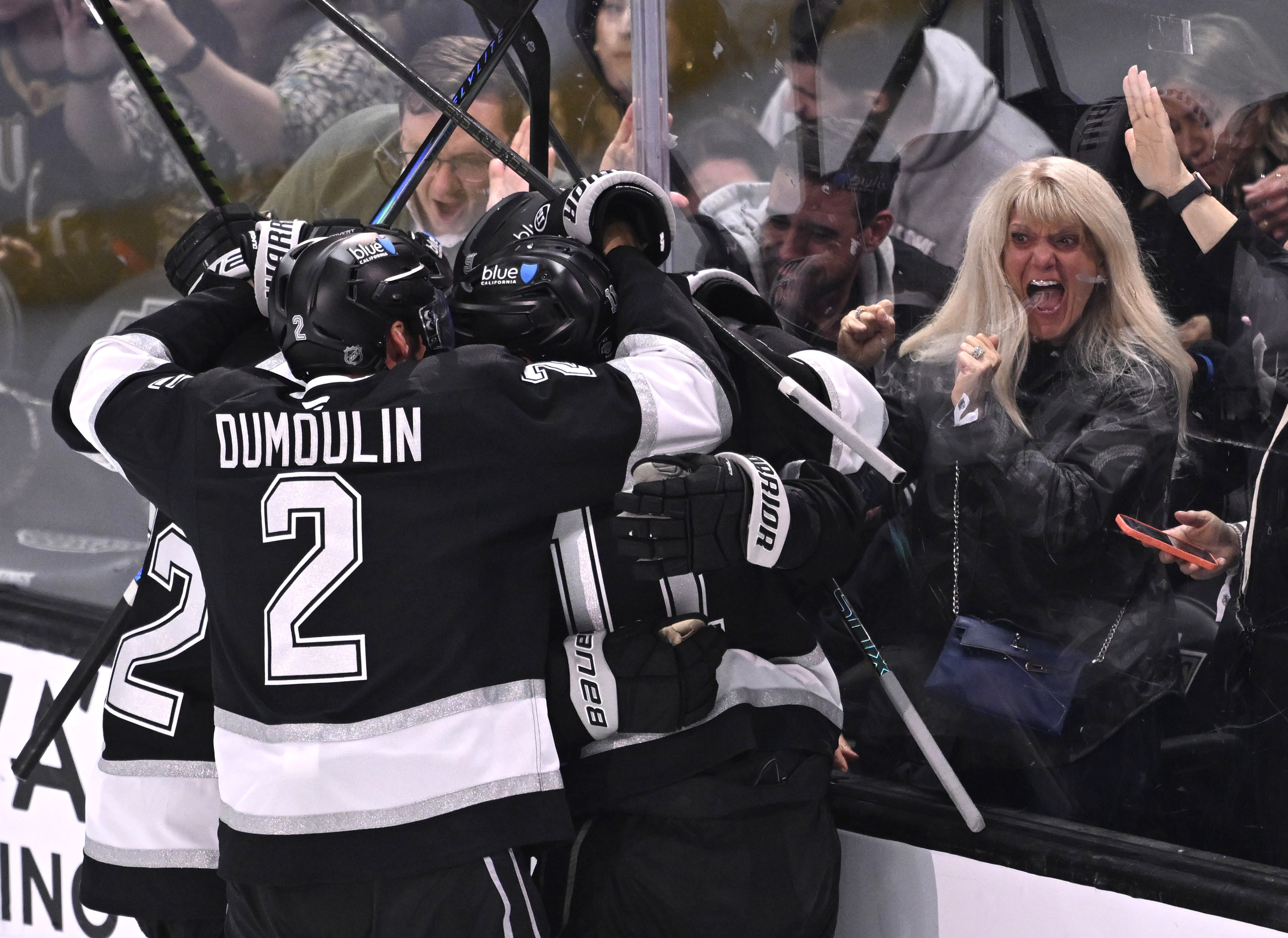 Kings right wing Adrian Kempe (9) celebrates with teammates after...