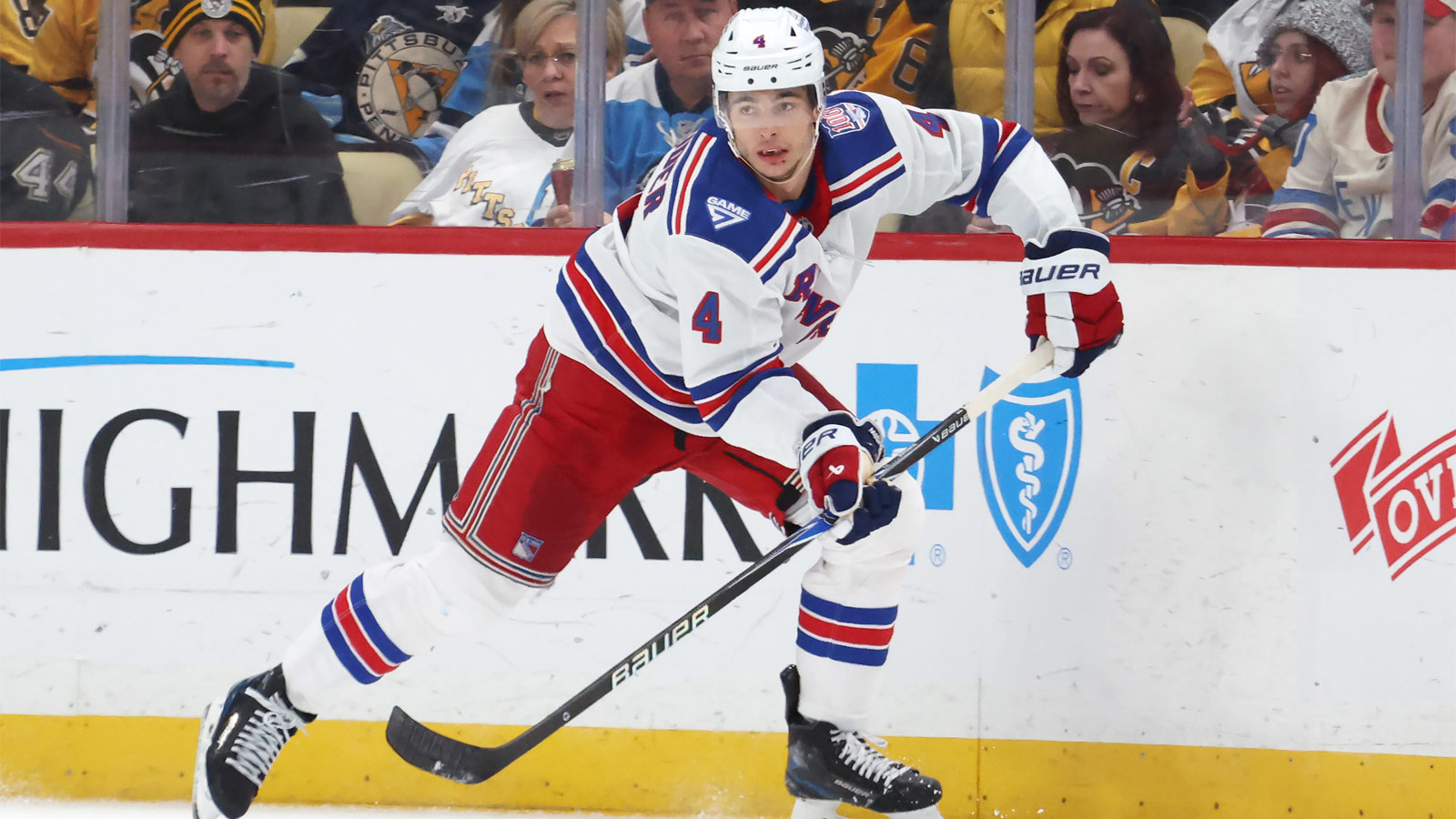 New York Rangers defenseman Braden Schneider (4) moves the puck against the Pittsburgh Penguins during the second period at PPG Paints Arena.
