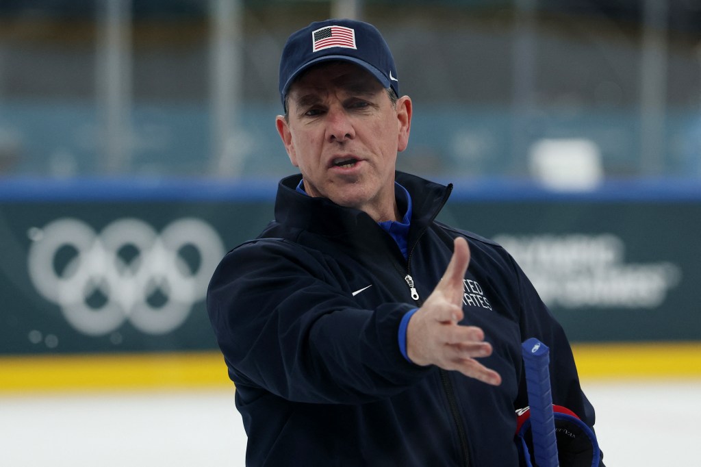 Ice hockey coach Mike Sullivan in a navy jacket and USA baseball cap, gesturing with his hand.
