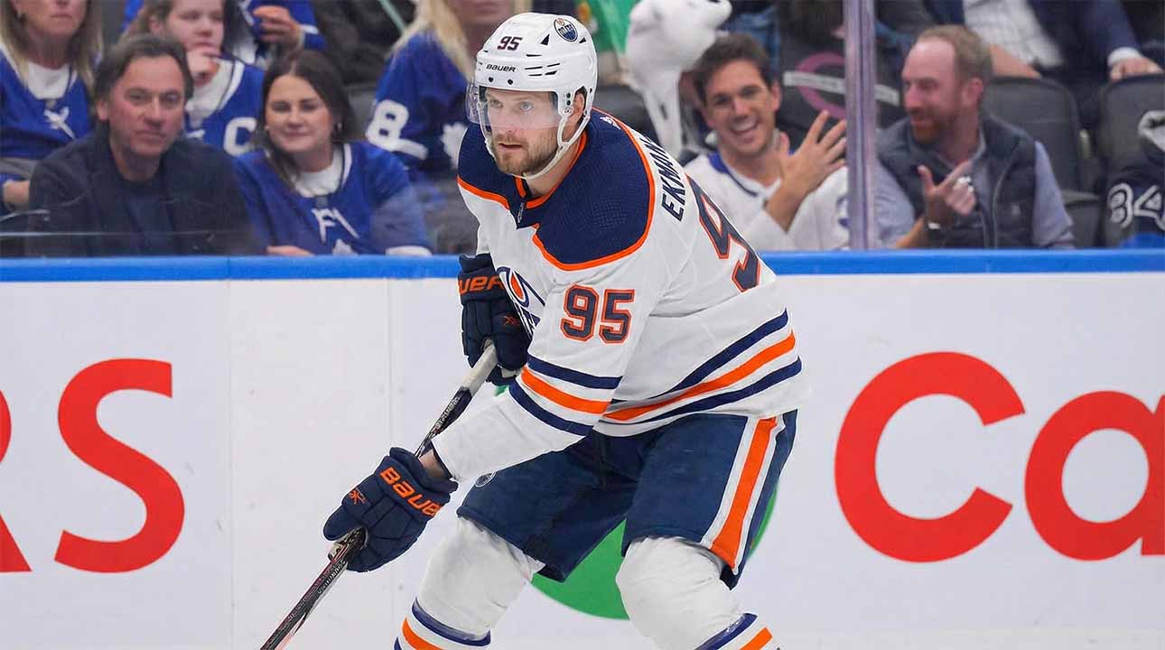 A concept visualization showing current Toronto Maple Leafs defenseman Oliver Ekman-Larsson (95) wearing a white Edmonton Oilers away jersey, helmet, and gloves, skating with the puck during a game environment.