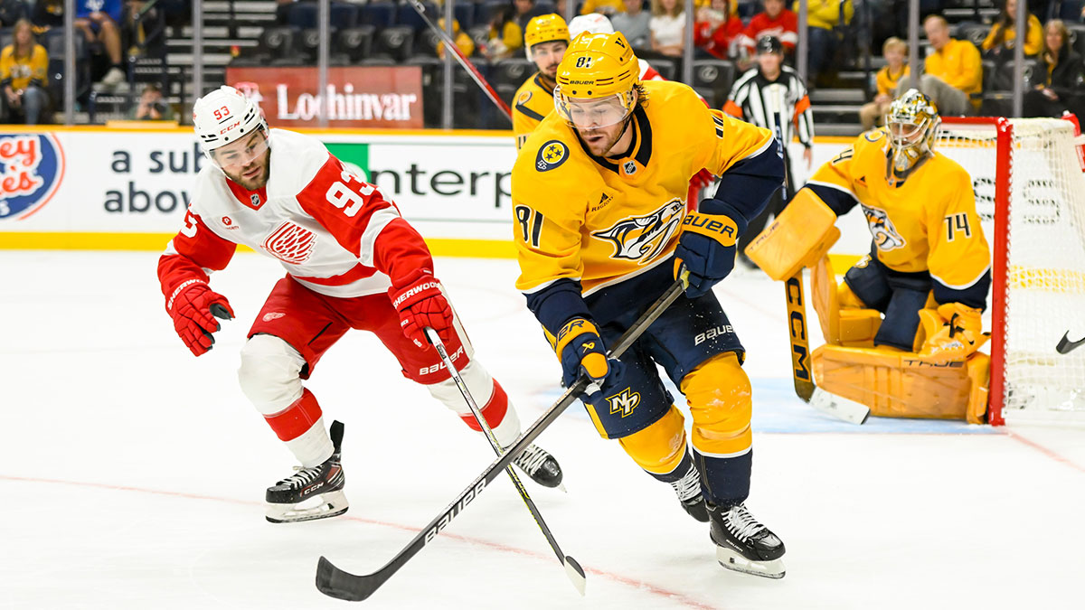 Nashville Predators center Jonathan Marchessault (81) skates as Detroit Red Wings right wing Alex DeBrincat (93) pokes at the puck during the second period at Bridgestone Arena.